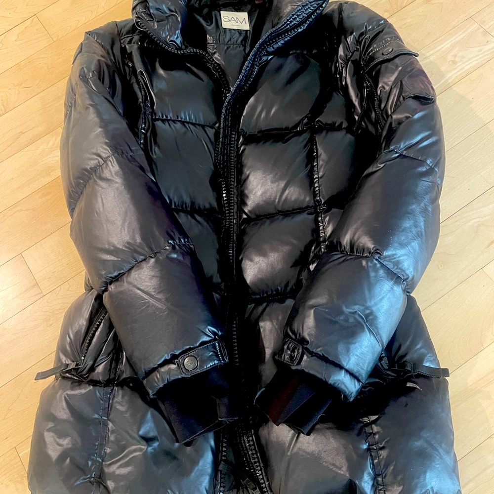 SAM. black puffer jacket with high-shine finish, front zip closure.